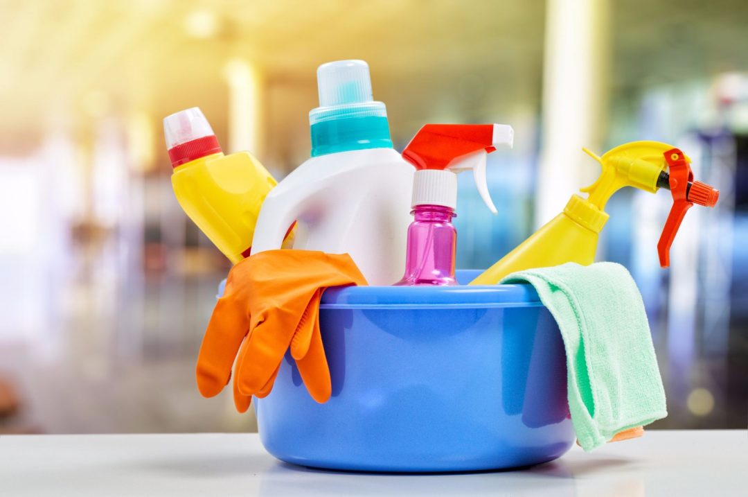 Colourful cleaning supplies in a bucket